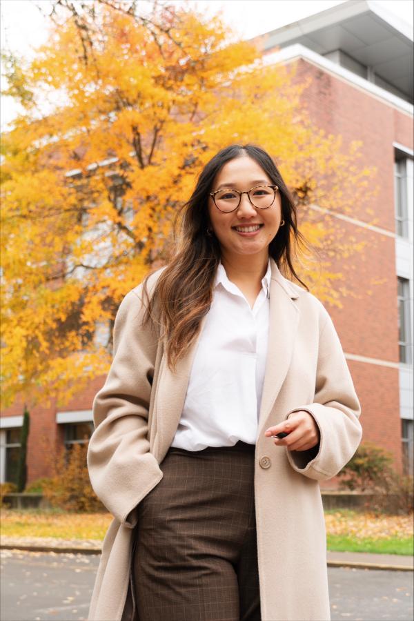 Pachi posing in front of a building in the fall